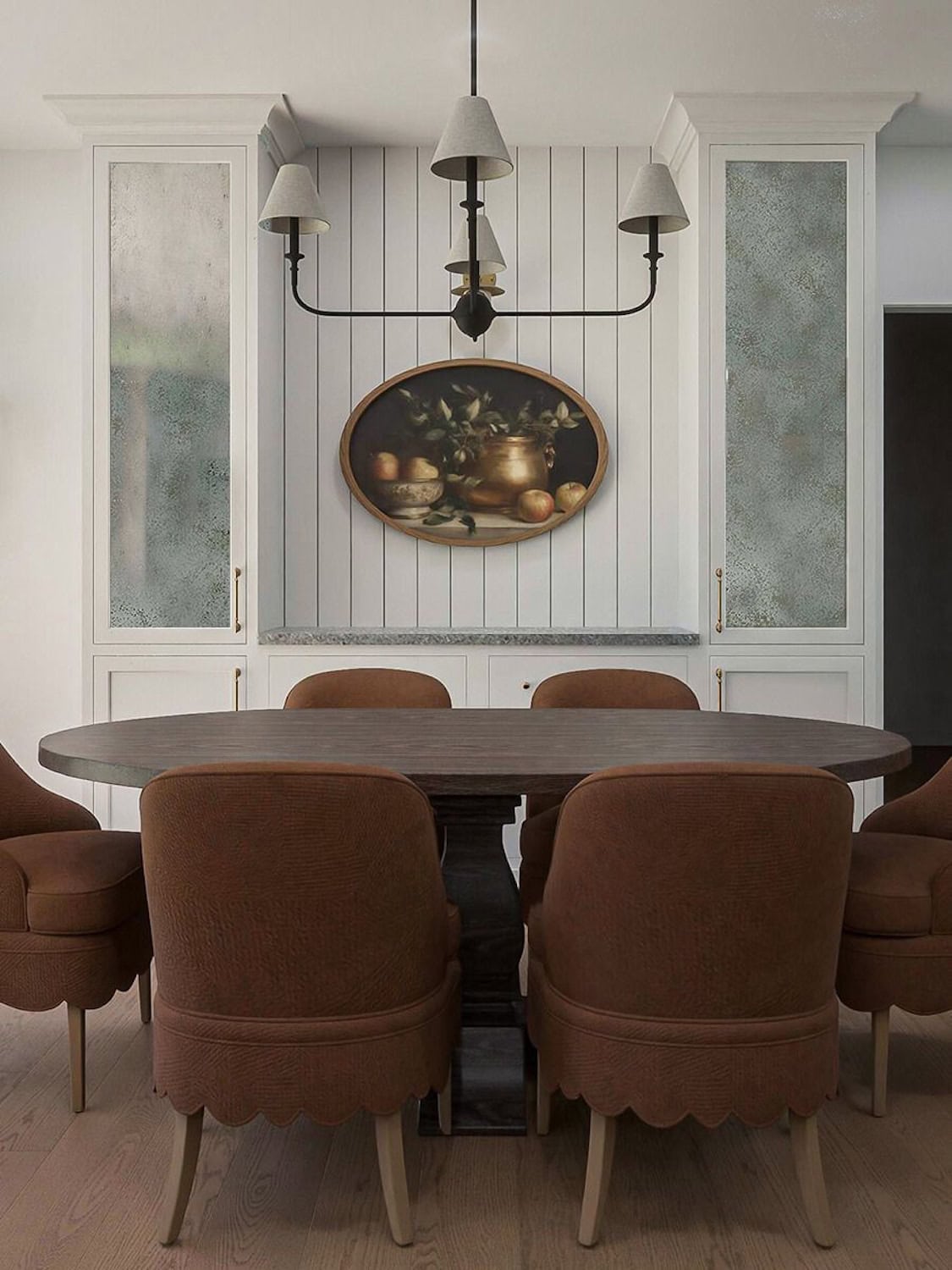 Dining room materials in the Orchard Drive project featuring a round wood table, scalloped dining chairs, custom built-in cabinetry, and vertical paneling.